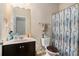 Cozy bathroom with decorative shower curtain, vanity, and neutral color scheme at 6918 Diamond Dr, Rex, GA 30273