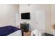 Bright bedroom with carpeted floors, television, and ample storage at 6918 Diamond Dr, Rex, GA 30273