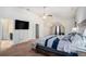 This primary bedroom features plush carpeting, a ceiling fan, a TV, a walk-in closet, and an ensuite bathroom at 6918 Diamond Dr, Rex, GA 30273