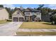 Charming two-story home with a well-maintained lawn and a two-car garage at 6918 Diamond Dr, Rex, GA 30273