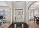 Inviting foyer featuring dark hardwood floors, a bright windowed front door, and high ceilings at 6918 Diamond Dr, Rex, GA 30273
