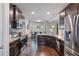 Spacious kitchen with stainless steel appliances, granite countertops, and dark wood flooring at 6918 Diamond Dr, Rex, GA 30273