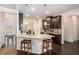 Modern kitchen featuring granite countertops, stainless steel appliances, and dark wood cabinets at 6918 Diamond Dr, Rex, GA 30273