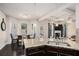 Kitchen featuring granite countertops, dark wood cabinets, and an adjoining dining area at 6918 Diamond Dr, Rex, GA 30273