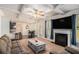 Bright, open-concept living room with modern fireplace, coffered ceiling, and an adjacent dining area at 6918 Diamond Dr, Rex, GA 30273