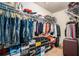 This walk-in closet features carpet flooring and plenty of storage for clothes, shoes, and luggage at 6918 Diamond Dr, Rex, GA 30273
