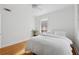 A bright bedroom with hardwood floors and one window featuring a white duvet at 1026 Saint Charles Ne Ave # 8, Atlanta, GA 30306