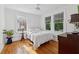 A bright bedroom features hardwood floors and two windows that bring in natural light at 1026 Saint Charles Ne Ave # 8, Atlanta, GA 30306