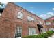 Exterior of a red brick apartment building featuring black awnings and classic architectural details at 1026 Saint Charles Ne Ave # 8, Atlanta, GA 30306