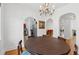 Bright dining room with chandelier, hardwood floors, and arched doorway at 1026 Saint Charles Ne Ave # 8, Atlanta, GA 30306