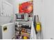 A laundry area with stackable washer and dryer next to a shelving system with toaster oven at 1026 Saint Charles Ne Ave # 8, Atlanta, GA 30306