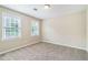 Bright bedroom featuring two windows and neutral carpet at 1107 Leslie Pl, Lithonia, GA 30058