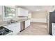 Well-lit kitchen with white cabinets, granite countertops, and stainless steel appliances at 1107 Leslie Pl, Lithonia, GA 30058