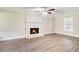 Bright living room featuring a cozy fireplace, wood floors, and a window at 1107 Leslie Pl, Lithonia, GA 30058