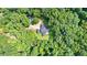 Aerial view of home surrounded by lush green trees, highlighting its private and secluded setting at 12550 Hutcheson Ferry Rd, Palmetto, GA 30268