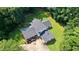 Stunning aerial view of a home with a well-maintained lawn, surrounded by lush trees and a driveway at 12550 Hutcheson Ferry Rd, Palmetto, GA 30268