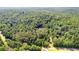 Overhead view of a home surrounded by lush greenery and rolling hills at 12550 Hutcheson Ferry Rd, Palmetto, GA 30268