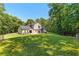 Large backyard with a building behind a large lawn at 12550 Hutcheson Ferry Rd, Palmetto, GA 30268