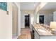 Bathroom featuring granite counters, dual sinks, vanity, and a walk-in closet at 12550 Hutcheson Ferry Rd, Palmetto, GA 30268