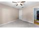 This bedroom features neutral walls, gray carpeting, and a ceiling fan with a light at 12550 Hutcheson Ferry Rd, Palmetto, GA 30268