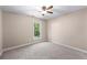 Minimalist bedroom featuring neutral walls, carpet, and a bright window at 12550 Hutcheson Ferry Rd, Palmetto, GA 30268