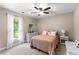 Charming bedroom with a cozy bed, soft carpet, and lots of natural light at 12550 Hutcheson Ferry Rd, Palmetto, GA 30268
