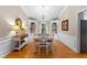 Elegant dining room with hardwood floors, wainscoting, built-in shelving, and a chandelier at 12550 Hutcheson Ferry Rd, Palmetto, GA 30268
