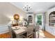 Elegant dining room with hardwood floors, wainscoting, built-in shelving, and a chandelier at 12550 Hutcheson Ferry Rd, Palmetto, GA 30268