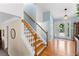 Bright foyer featuring hardwood floors, staircase, and a decorative glass front door at 12550 Hutcheson Ferry Rd, Palmetto, GA 30268