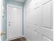 Hallway featuring hardwood floors with adjacent closet and door at 12550 Hutcheson Ferry Rd, Palmetto, GA 30268