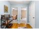 Hallway with hardwood floors leading to bedrooms with neutral decor at 12550 Hutcheson Ferry Rd, Palmetto, GA 30268