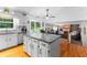 Bright kitchen with large island, stainless appliances, wood flooring, and a breakfast nook at 12550 Hutcheson Ferry Rd, Palmetto, GA 30268