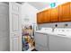 Bright laundry room with washer, dryer, cabinets, and shelving at 12550 Hutcheson Ferry Rd, Palmetto, GA 30268