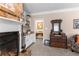 Elegant living room featuring a brick fireplace, built-in shelving, and an antique dresser with a mirror at 12550 Hutcheson Ferry Rd, Palmetto, GA 30268