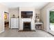 Cozy bedroom featuring a fireplace with a TV, built-in shelves, and access to an adjoining room at 12550 Hutcheson Ferry Rd, Palmetto, GA 30268