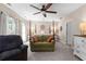 Spacious bedroom with a four-poster bed, ceiling fan, sitting area, and large windows for natural light at 12550 Hutcheson Ferry Rd, Palmetto, GA 30268