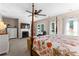 Bright bedroom featuring a four-poster bed, fireplace with a TV, and access to the backyard at 12550 Hutcheson Ferry Rd, Palmetto, GA 30268
