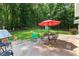 Covered patio with outdoor seating, garden, and green lawn at 12550 Hutcheson Ferry Rd, Palmetto, GA 30268