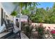 Charming front porch with rocking chairs, hanging plants, flowers, and a basketball hoop in the driveway at 12550 Hutcheson Ferry Rd, Palmetto, GA 30268