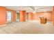 Finished basement space featuring carpet and vinyl flooring and light orange walls at 155 Skyview Dr, Social Circle, GA 30025