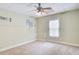 Basement room featuring neutral carpeting, window and electrical panel access at 155 Skyview Dr, Social Circle, GA 30025