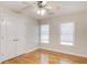 Bedroom with hardwood floors, ceiling fan, and two windows dressed with white blinds for ample natural light at 155 Skyview Dr, Social Circle, GA 30025