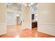 Elegant dining room showcasing wainscoting, hardwood floors, and open access to other rooms at 155 Skyview Dr, Social Circle, GA 30025