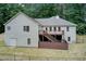 Back view of the home with an elevated deck accessible via stairs and a fenced in backyard at 155 Skyview Dr, Social Circle, GA 30025