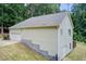 Rear corner of a home with siding, showing the two-car garage and back door to the property at 155 Skyview Dr, Social Circle, GA 30025