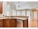 Kitchen with wood cabinets, laminate countertops, stainless steel dishwasher, hardwood floors and pendant lighting at 155 Skyview Dr, Social Circle, GA 30025