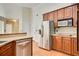 Well-equipped kitchen featuring stainless steel appliances, wooden cabinets, and ample counter space at 155 Skyview Dr, Social Circle, GA 30025