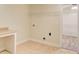Laundry room features linoleum flooring, wire rack storage, a desk and a door to an adjacent room at 155 Skyview Dr, Social Circle, GA 30025