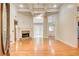 Spacious living room featuring a fireplace, high ceilings, and gleaming hardwood floors at 155 Skyview Dr, Social Circle, GA 30025