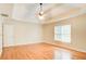 Serene main bedroom with a tray ceiling, ceiling fan, and large windows offering natural light at 155 Skyview Dr, Social Circle, GA 30025